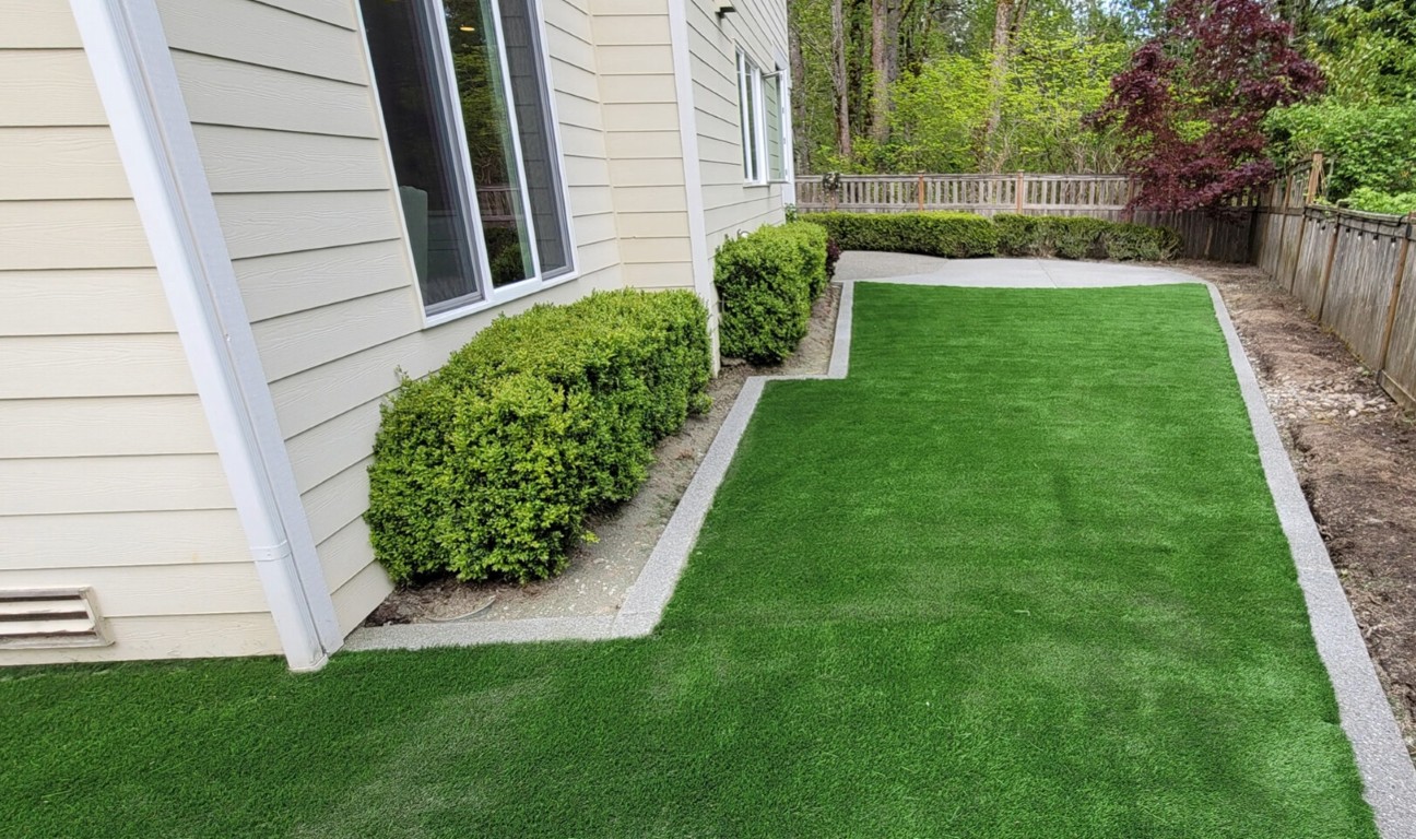 Professional artificial grass installation in residential backyard in Bellevue, NE